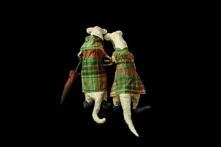 Isolated on black papier-mache a pair of old enamored mice with an umbrellaの写真素材