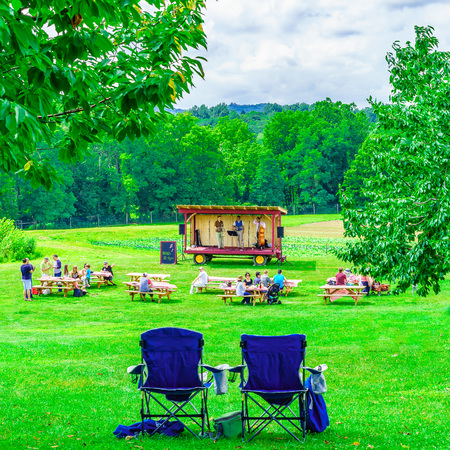 Upstate New York USA - August 12, 2017 Country music band on platform Green field, landscape of meadow with grass USのeditorial素材