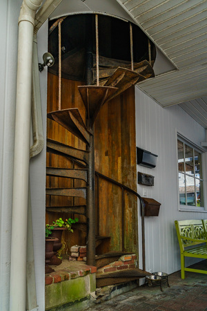 Old yard with a spiral staircase. Entrance to home from the street Cape Cod Provincetown has a large gay population of residents and tourists Massachusetts USAの写真素材