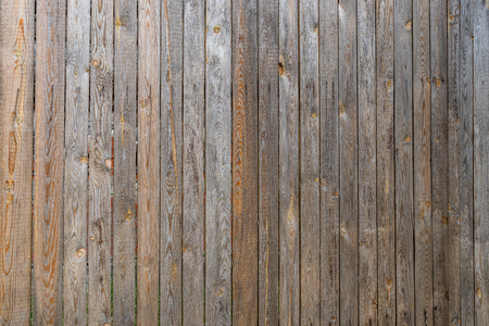 Fence of old unpainted boards background closeup.の写真素材