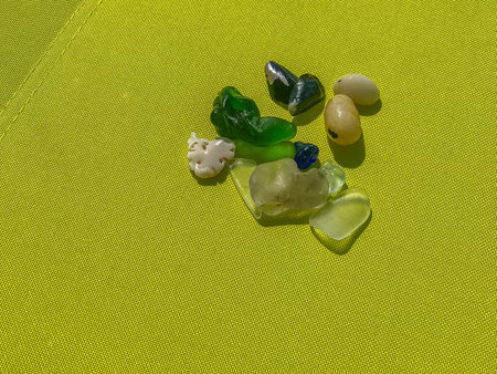 Colored glass pebbles in the background of canvas.