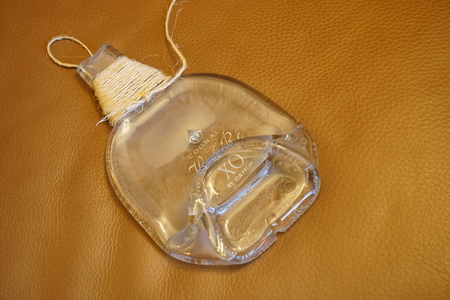 Melted Glass Bottle with coiled ropeの写真素材