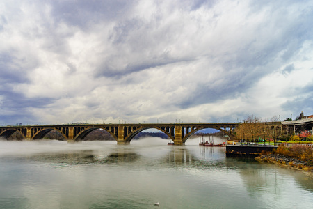 Francis Scott Key Bridge across Potomac River, winter fog on the water.の写真素材