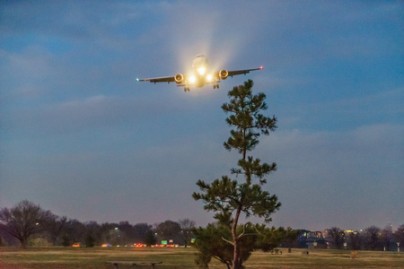 Plane lands at Ronald Reagan Washington National Airport Gravelly Point at nightの写真素材