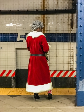 Slim santa claus woman in subway Manhattan NYの写真素材