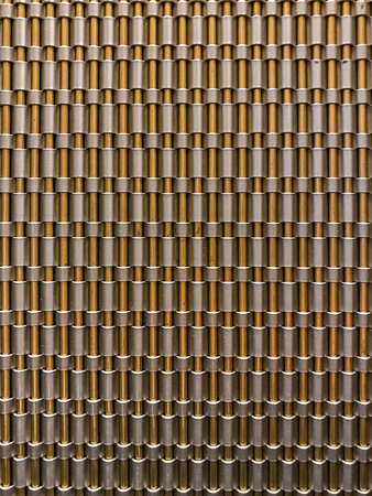 vertical metal short tubes and shiny rods.の写真素材