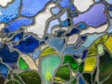 Multicolor mosaic wall decorative ornament from ceramic and glass broken tile.の写真素材