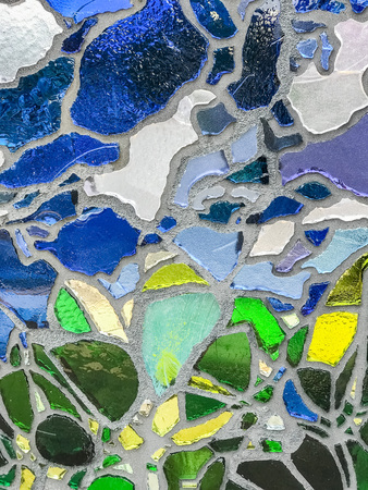 Multicolor mosaic wall decorative ornament from ceramic and glass broken tile.の写真素材