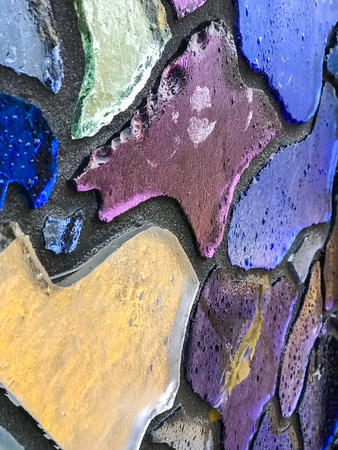 Multicolor mosaic wall decorative ornament from ceramic and glass broken tile.の写真素材