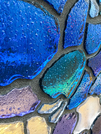 Multicolor mosaic wall decorative ornament from ceramic and glass broken tile.の写真素材