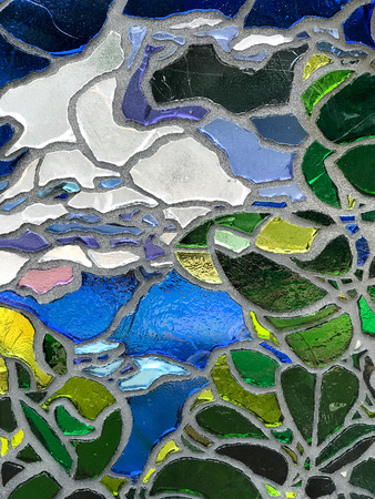 Multicolor mosaic wall decorative ornament from ceramic and glass broken tile.の写真素材