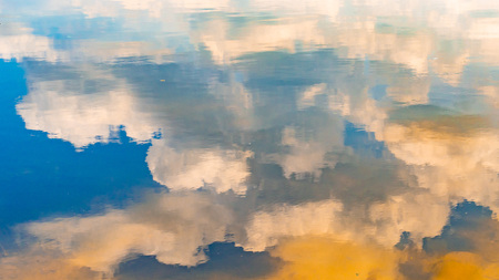 Reflection in the water of the sky and the bottom of the riverの写真素材