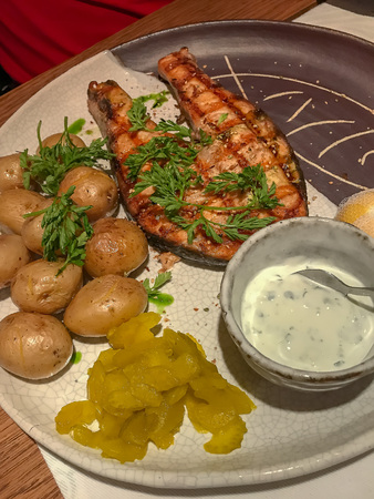 Grilled salmon with small unpeeled boiled potatoes.の写真素材