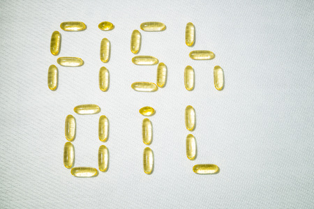 Top view of Fish oil capsules on white background. Omega 3. Vitamin E. Supplement food for good lifeの写真素材