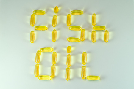 Top view of Fish oil capsules on white background. Omega 3. Vitamin E. Supplement food for good lifeの写真素材