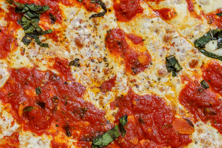 A real tasty cheese pizza from a restaurant as background.の写真素材