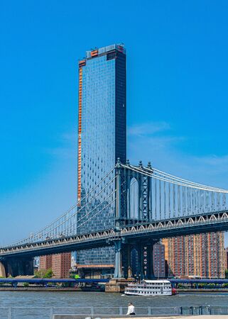 Manhattan Bridge over East River and waterfront condominium Manhattan New York Cityの写真素材