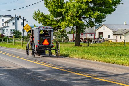 Amish Country, Lancaster PA US - September 4 2019,house, fence, tree, grass on the road between the fields in Lancaster, PA US.の写真素材