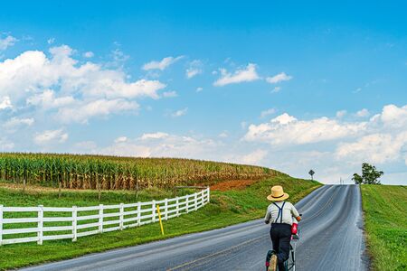 Amish country farm field agriculture, boy on a scooter in Lancaster, PA USの写真素材