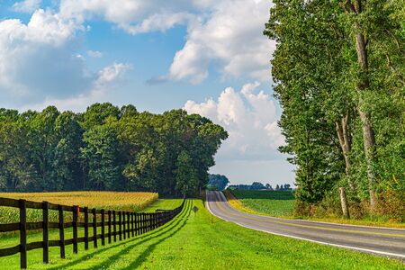 Amish country field agriculture, beautiful brown wooden fence, farm, barn in Lancaster, PA US.の写真素材