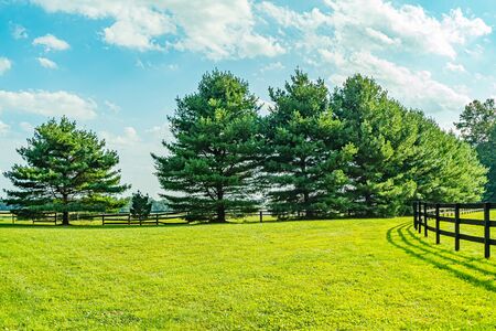 Amish country field agriculture, beautiful brown wooden fence, farm, barn in Lancaster, PA US.の写真素材