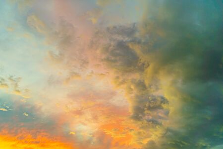 White, orange, blue and dark clouds on sky on the sunset summer background Georgia, US.の写真素材