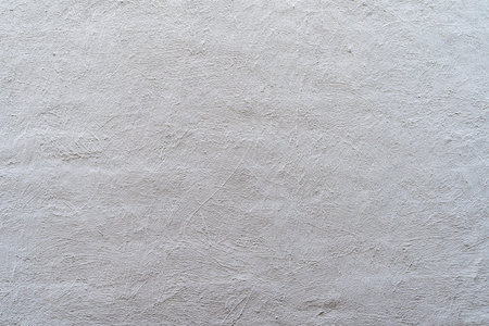 decoratively plastered wall painted with light paint background