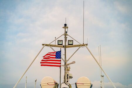 Provincetown Marina star and stripes reflected in the water Provincetown MA US.の写真素材