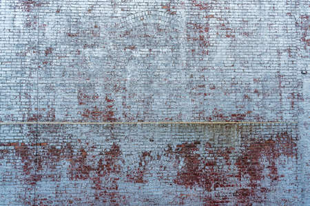 Old red brickwork covered with white paint, background textureの写真素材