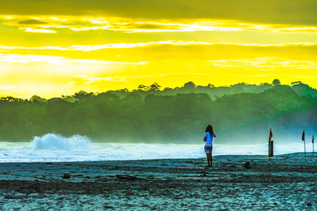 Sunrise at Playa Cocles, beautiful tropical Caribbean beach, Puerto Viejo, Costa Rica east coast, tourists meet the dawnの写真素材
