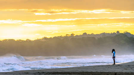 Sunrise at Playa Cocles, beautiful tropical Caribbean beach, Puerto Viejo, Costa Rica east coast, tourists meet the dawnの写真素材