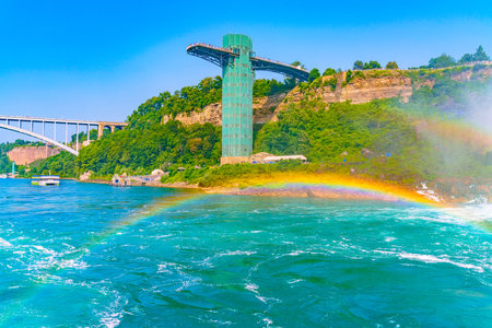 Huge rainbow, view on Bridal Veil Falls and Observation Tower, Niagara River downstream after Niagara Falls, American river bank. High quality photoの写真素材