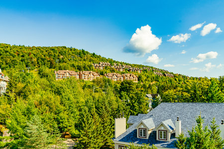 Mont Tremblant, beautiful national park and village in perfect harmony with nature. Tiled roofs of hotels. The unique and wonderful Mont-Tremblant resort village, Quebec, Canada. High quality photoの写真素材