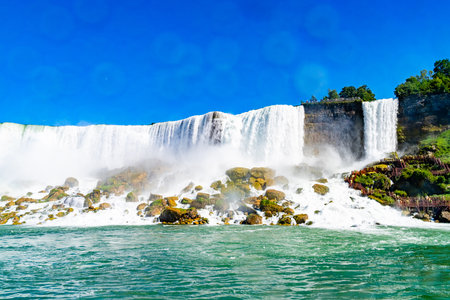 View on the Bridal Veil Falls and American Falls of the Niagara Falls, the part of Goat Island, the Cave of the Winds Lookout, stairs and platforms, wooden walkways, Niagara Falls, New York, USA High quality photo.の写真素材