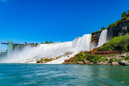 View on the Bridal Veil Falls and American Falls of the Niagara Falls, the part of Goat Island, the Cave of the Winds Lookout, stairs and platforms, wooden walkways, Niagara Falls, New York, USA High quality photo.の写真素材