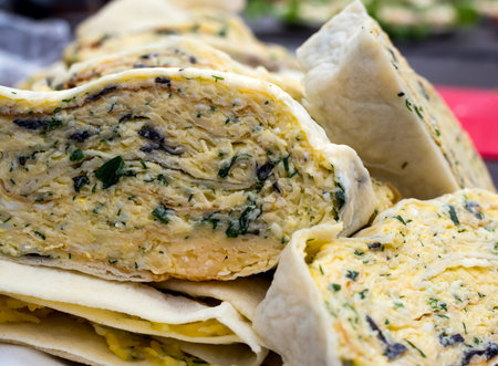 Roll of pita stuffed with cheese and herbs