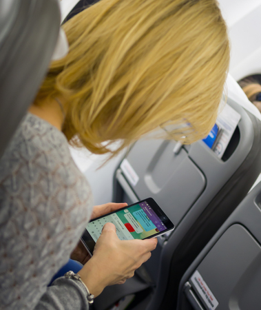 Moscow, Russia - December 29, 2015: The woman in the cabin writing an SMS using the phoneのeditorial素材