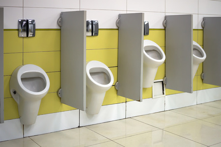 Urinals in a public toilet installed at various heights for high and low peopleのeditorial素材