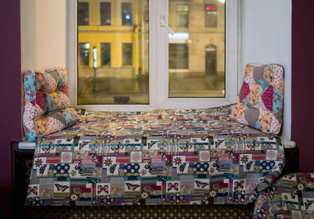 Pillows and mattresses lie on the windowsill as a couch for relaxing