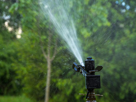 Automatic irrigation system waters the vegetation neighborhoodの写真素材