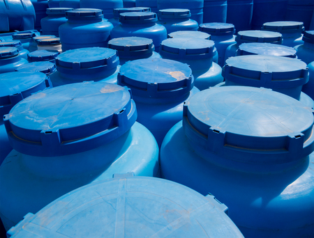 Blue plastic containers for storage of liquids in the storage areaの写真素材