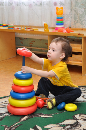 Gadjievo, Russia - April 28, 2011: A child collects a pyramidのeditorial素材