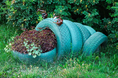 A flower in the form of a frog made of used automobile tiresの写真素材