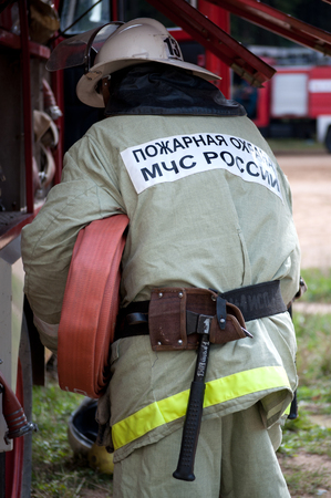 Yartsevo, Russia - August 26, 2011: The fireman pulls out the fire hose from the carのeditorial素材