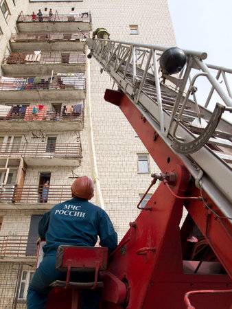 Yartsevo, Russia - August 26, 2011: The fireman is climbing the rescue ladder