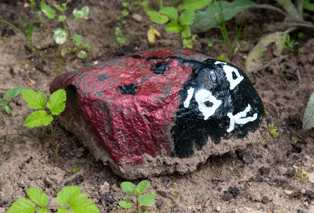Ladybird made from a small stone for decorating a garden plotの写真素材