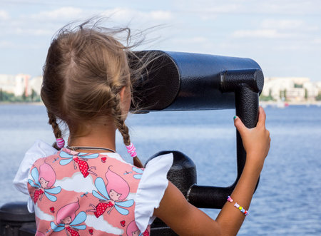 Voronezh, Russia - August 13, 2018: The girl looks into the binocularsのeditorial素材