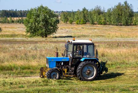 Zadonsk, Russia - August 22, 2018: Tractor rides on the edge of a field in the countrysideのeditorial素材