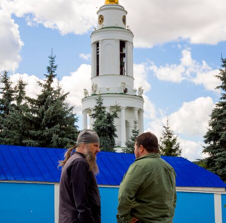 Zadonsk, Russia - August 28, 2018: Conversation of a priest with a parishioner near St. Nicholas Churchのeditorial素材