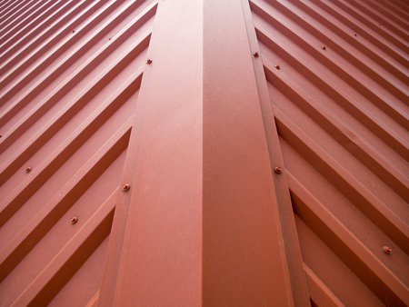 Fragment of the roof of a building covered with a metal gofrolist